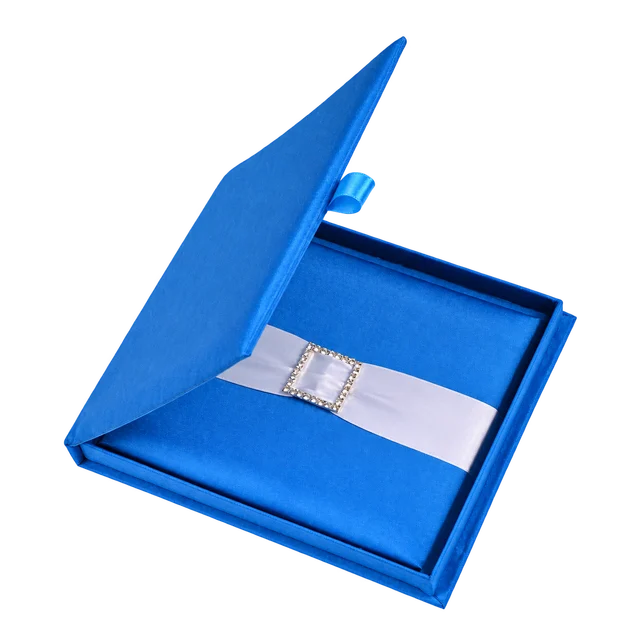 Royal blue silk invitation box with a white ribbon and square jeweled embellishment