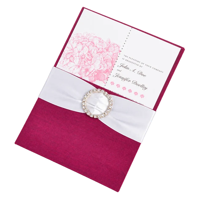 Magenta silk pocket folio with invitation card, white ribbon and jeweled embellishment